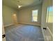 Neutral bedroom showcasing plush carpet, a window providing natural light, and an open doorway to the walk-in closet at 3850 Willow Grove Ln # 24, Concord, NC 28025