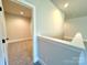 Light hallway with view of the bonus room, showcasing carpeted floors and an airy, open atmosphere at 3850 Willow Grove Ln # 24, Concord, NC 28025
