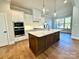 Kitchen boasts stainless appliances, a wooden island, white countertops, and modern pendant lighting at 3850 Willow Grove Ln # 24, Concord, NC 28025