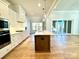 Bright kitchen features white cabinets, stainless appliances, and a center island with marble countertops at 3850 Willow Grove Ln # 24, Concord, NC 28025
