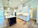 Bright kitchen with white cabinetry, a center island, stainless appliances, and hardwood floors at 3850 Willow Grove Ln # 24, Concord, NC 28025
