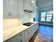Kitchen showcases white cabinets, marble countertops, geometric backsplash, and wood flooring at 3850 Willow Grove Ln # 24, Concord, NC 28025