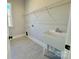 Functional laundry room featuring a utility sink, a white faucet, a window for natural light, and tile flooring at 3850 Willow Grove Ln # 24, Concord, NC 28025