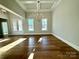 Spacious living room features hardwood floors, elegant lighting, and large windows at 3850 Willow Grove Ln # 24, Concord, NC 28025