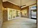 Cozy outdoor living area featuring a ceiling fan, brick siding, and sliding glass doors at 3850 Willow Grove Ln # 24, Concord, NC 28025