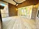 Covered porch with wood flooring and brick siding, complete with outdoor ceiling fan at 3850 Willow Grove Ln # 24, Concord, NC 28025
