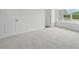Carpeted bedroom features natural light from windows and has neutral paint at 5527 Stafford Rd # 34, Charlotte, NC 28215