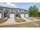 New townhome row with light gray siding, white trim and one-car garages at 5527 Stafford Rd # 34, Charlotte, NC 28215
