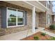 Inviting covered front porch with craftsman columns and professionally landscaped yard at 5527 Stafford Rd # 34, Charlotte, NC 28215