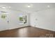 Bright living space with hardwood floors and a large window at 5527 Stafford Rd # 34, Charlotte, NC 28215