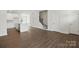 Open-concept living space with modern kitchen, hardwood floors and staircase at 5527 Stafford Rd # 34, Charlotte, NC 28215