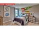 Bright bedroom with skateboard wall art and a dresser at 11060 Adair Woods Dr, Davidson, NC 28036