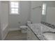 Bright bathroom with granite vanity, white fixtures, and a window providing natural light at 1647 Davis Farm Rd, York, SC 29745