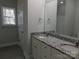 Bathroom featuring double sinks, granite countertops, a mirror and a bright window at 1647 Davis Farm Rd, York, SC 29745
