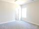 A bright bedroom with neutral walls and carpet; filled with natural light from the window at 1647 Davis Farm Rd, York, SC 29745