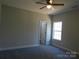 A bright bedroom with neutral walls and carpet; filled with natural light from the window at 1647 Davis Farm Rd, York, SC 29745