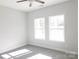 Bright bedroom featuring carpet, neutral walls, and natural light from two windows at 1647 Davis Farm Rd, York, SC 29745