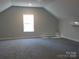 Spacious bonus room featuring a window, ceiling fan, and neutral carpet and paint at 1647 Davis Farm Rd, York, SC 29745