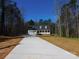 Exterior of new construction home with white siding, dormer windows, front porch, and an attached two-car garage at 1647 Davis Farm Rd, York, SC 29745