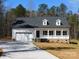 Charming single-story home with white siding, dormer windows, front porch, and an attached two-car garage at 1647 Davis Farm Rd, York, SC 29745