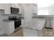 New kitchen boasts white cabinets, granite countertops, stainless steel appliances, and a convenient center island at 1647 Davis Farm Rd, York, SC 29745