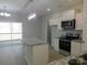 Well-lit kitchen with a center island, white cabinets, stainless steel appliances, and a sliding glass door to the deck at 1647 Davis Farm Rd, York, SC 29745