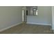 Open concept living room with light walls and vinyl floors, showing a passthrough to the kitchen at 1647 Davis Farm Rd, York, SC 29745