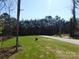 Large grassy yard and long driveway leading to the property at 1647 Davis Farm Rd, York, SC 29745