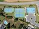 Aerial view of community tennis and basketball courts near a pool and parking area at 1716 Funny Cide Dr, Waxhaw, NC 28173