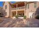Multi-level brick home showcasing upper balcony and lower patio with outdoor seating at 1716 Funny Cide Dr, Waxhaw, NC 28173