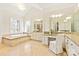 This bathroom features a soaking tub, double vanity, granite counters, and a makeup vanity with a white chair at 1716 Funny Cide Dr, Waxhaw, NC 28173