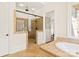 This bathroom features a glass door shower, tiled walls, a soaking tub, and built in shelves outside the door at 1716 Funny Cide Dr, Waxhaw, NC 28173