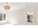 Bright bedroom features a modern chandelier, two large windows and neutral paint at 1716 Funny Cide Dr, Waxhaw, NC 28173