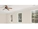 Bedroom featuring three large windows, wood trim, and a ceiling fan at 1716 Funny Cide Dr, Waxhaw, NC 28173