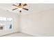 Bedroom with neutral walls, white trim, neutral carpet, large window, and a ceiling fan at 1716 Funny Cide Dr, Waxhaw, NC 28173