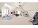 Spacious bonus room with vaulted ceilings, ample natural light, and neutral color palette at 1716 Funny Cide Dr, Waxhaw, NC 28173