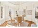 Sunlit breakfast nook with a round table, wicker chairs, and views of the surrounding landscape at 1716 Funny Cide Dr, Waxhaw, NC 28173