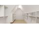 Walk-in closet with white shelving, cabinets, and storage bins, with neutral colored carpet at 1716 Funny Cide Dr, Waxhaw, NC 28173