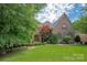 Charming brick home with a beautiful landscaped front yard and architectural details at 1716 Funny Cide Dr, Waxhaw, NC 28173