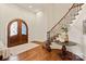 Grand foyer with hardwood floors, staircase, and arched entryways at 1716 Funny Cide Dr, Waxhaw, NC 28173