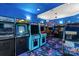 Vibrant game room with classic arcade games, colorful decor, and unique carpeting at 1716 Funny Cide Dr, Waxhaw, NC 28173