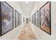 Long hallway with tile floors, movie posters, and recessed lighting at 1716 Funny Cide Dr, Waxhaw, NC 28173