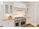 Gourmet kitchen features a professional range, custom cabinets, and stone countertops at 1716 Funny Cide Dr, Waxhaw, NC 28173
