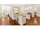 Bright kitchen featuring granite counters, stainless steel appliances, and pendant lighting at 1716 Funny Cide Dr, Waxhaw, NC 28173