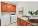 Functional laundry room with built-in cabinets and granite countertops around sink at 1716 Funny Cide Dr, Waxhaw, NC 28173