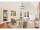 Elegant living room featuring a vaulted ceiling, ample natural light, and stylish seating at 1716 Funny Cide Dr, Waxhaw, NC 28173