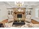 Inviting living room features a stone fireplace flanked by built-in bookshelves and stylish decor at 1716 Funny Cide Dr, Waxhaw, NC 28173