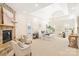 Spacious main bedroom with a stone fireplace, tray ceiling, and sitting area at 1716 Funny Cide Dr, Waxhaw, NC 28173
