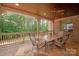 Outdoor patio with stone flooring, ceiling fan, and views of the surrounding woods, ideal for relaxation at 1716 Funny Cide Dr, Waxhaw, NC 28173
