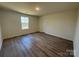 Simple bedroom with gray vinyl flooring and a window at 174 Salem Springs Ln, Statesville, NC 28625
